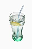 A glass of water with a slice of lemon and a straw