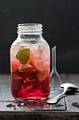Sangria with crushed ice, lemon and mint in a screw-top jar