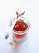 Quince jelly in jar with spoon