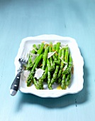 Green asparagus with orange butter and a Parmesan grater