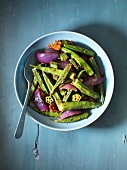 Okra pods with red onions