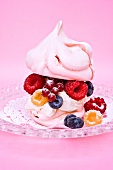 Pink meringue filled with cream and fresh berries