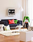 Cheerful living room with colourful stacking stools and side table elements in white plastic