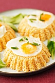 Millet cakes with fried quail's eggs