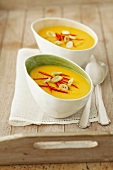 Cream of pumpkin soup with chilli strips and spring onions