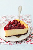 A slice of cheesecake with sour cherry jelly