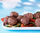 Meatballs on a bed of grilled vegetables