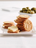 Round crackers with cheese and olives