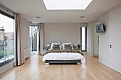 Elegant designer style bedroom with floor to ceiling windows