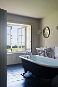 Free standing rolltop bath in home of fabric designer Richard Smith in East Sussex