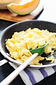 Scrambled Eggs in a Skillet with a Rubber Spatula