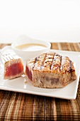 Grilled Sliced Tuna on a White Plate; Shredded Veggie Salad