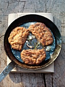Escalopes with a nut crust in a pan