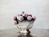 Frozen Red Grapes in a Small Silver Bowl