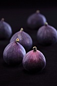 Fresh figs against a black background