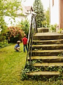 Old stone steps in the garden, children playing next to it