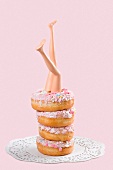 Doll legs in a stack of donuts