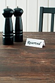 Salt and pepper mills and reserved sign