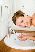 Young woman washing face