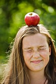 A girl with an apple on her head
