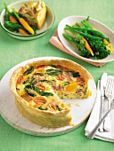 Shortcrust pastry quiche filled with bacon, egg, tomatoes and spinach