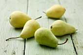 Five pears on a wooden surface