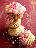 Various cupcakes decorated with pink frosting