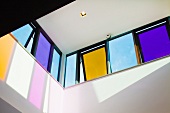 View upwards to coloured tilted windows in contemporary building