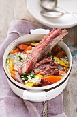 Beef stew with barley and soup vegetables in a pot