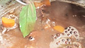 Vegetables being simmered with bones and spices (to make veal stock)