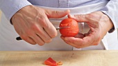 A tomato being peeled