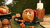 A baked apple on a table decorated for Christmas, with a sparkler