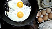 Two fried eggs in a pan