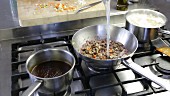 Bolognese sauce being made: pasta water being added to the meat and vegetable mixture