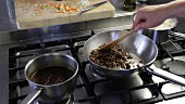 Bolognese sauce being made: minced meat being fried in a pan