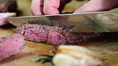 Fried entrecote being sliced