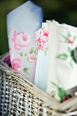 Various rose-patterned fabrics in wicker basket