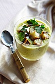 Gazpacho of cucumber topped with minted croutons, in a glass with a spoon