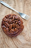 A sticky bun topped with pecan nuts (USA)