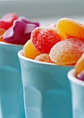 Colourful jelly sweets in blue cups