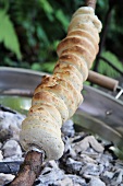Stick bread over a barbecue