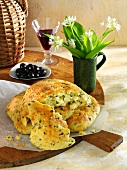 Potato and ramson bread and a dish of olives