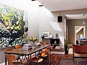 50s-style dining table and chairs below skylight in open-plan living area