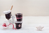 Plum sauce in jars in wintry surroundings