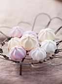 Pastel-coloured meringues on a wire rack