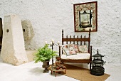 Majestic, antique chair next to birdcage and planter on loggia of Spanish house