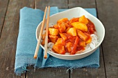Sweet and sour chicken on a bed of rice noodles (Asia)