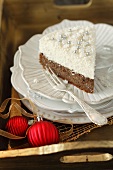 A slice of poppy seed cake with coconut mousse for Christmas