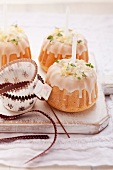 Mini Bunt cakes decorated with thyme, icing and candles
