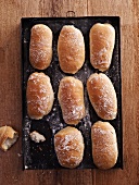 Fresh ciabatta rolls on a baking tray